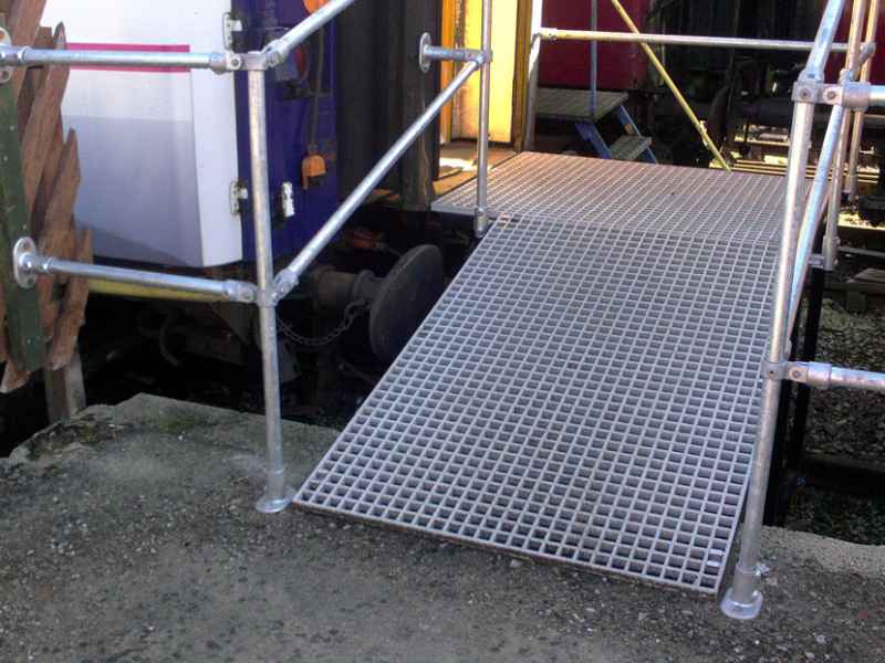 Grey grating access ramp into railway car