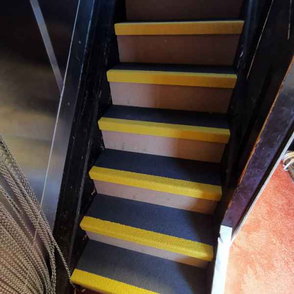 Black and yellow GRP stair tread covers