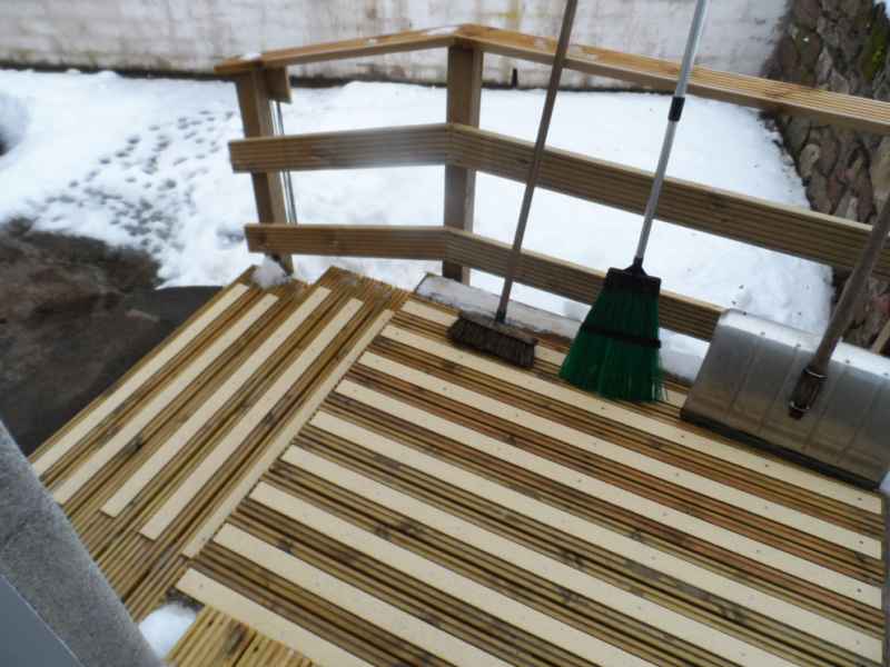 Buff decking strips on snow covered decking ramp steps