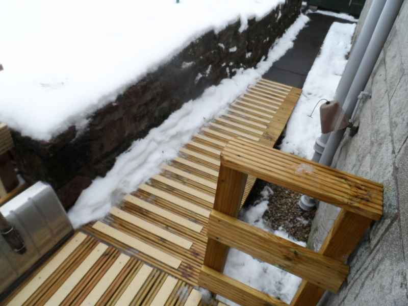 Buff GRP decking strips on snow covered decking ramp steps