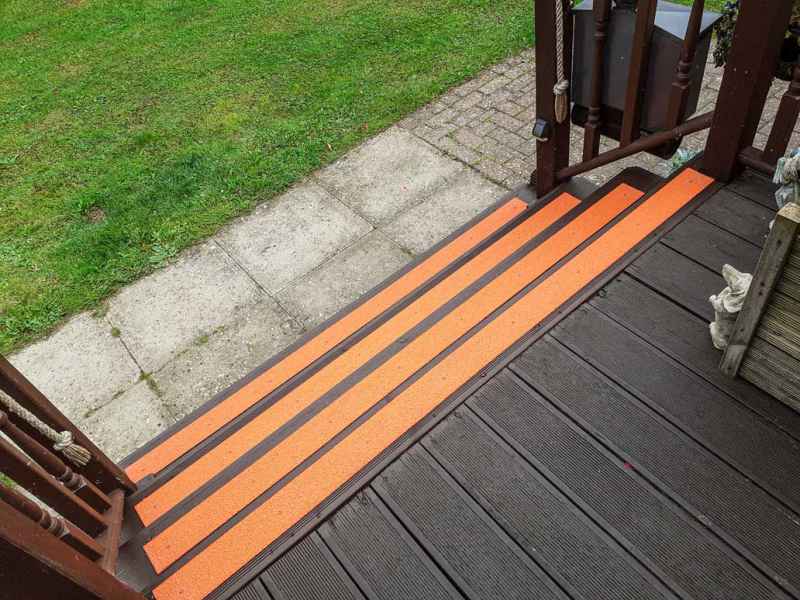 Orange anti slip 90mm decking strips on lodge steps