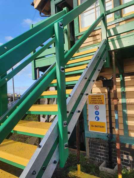 Yellow anti slip stair tread covers on external outdoor wooden staircase