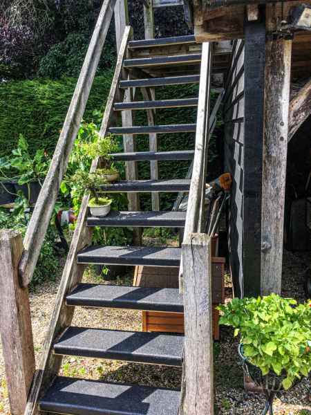 Black Anti slip stair tread covers on outdoor wooden steps