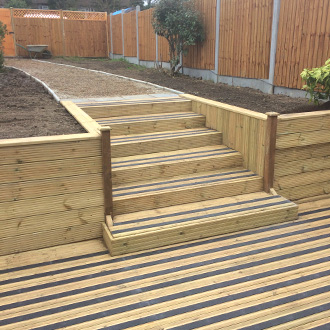 Patio decks and steps with black non-slip decking strips.