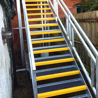Yellow and white Stair Treads exit stairway.