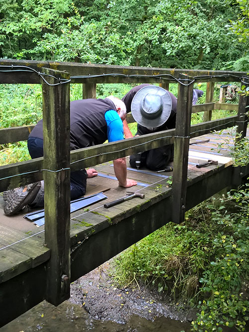 Preparing wooden treads on bridges and installing non-slip strips at the Harrington Nature Reserve.
