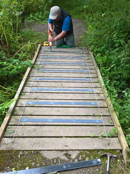 Replacing chicken wire with non-slip decking strips for the wooden footbridges throughout the Nature Reserve.