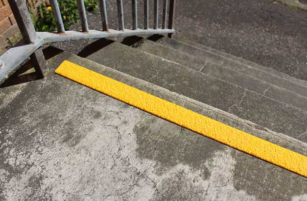 Anti-slip GRP strips for concrete worn steps, improving safety.
