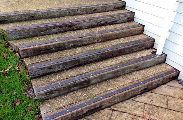 Wooden sleeper steps with hardwearing decking strips.