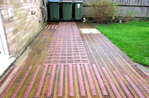 Back garden decking and bin area - a potential slip hazard made safe with decking strips.