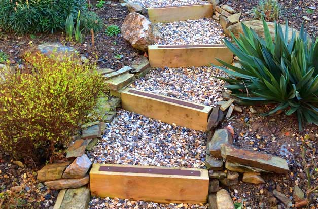 Beautiful garden sleeper steps with decking strips. Landscape design with safety in mind.