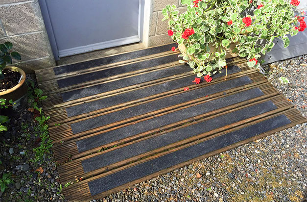 Anti-slip decking strips doorway safety.