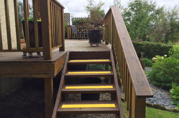 Yellow non-slip decking strips for garden steps.