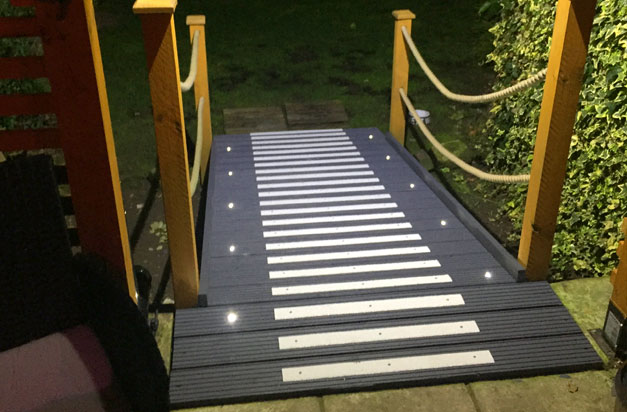 Glow in the dark, non-slip decking strips doorway entrance ramp.