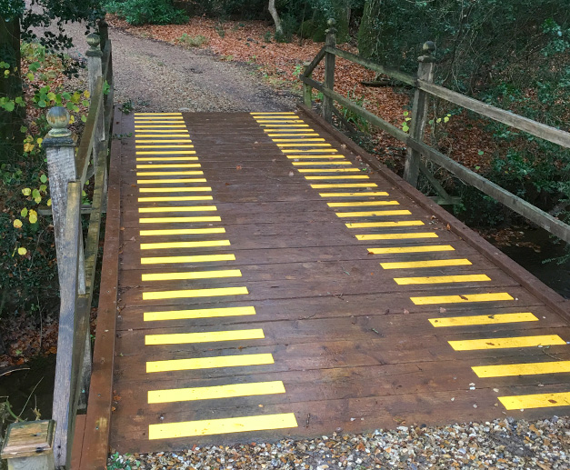 “Photos of installed anti slip products on wooden bridge to my house. They are nice and bright and provide good grip even in the rain. I am very pleased with products.” F McLeod.