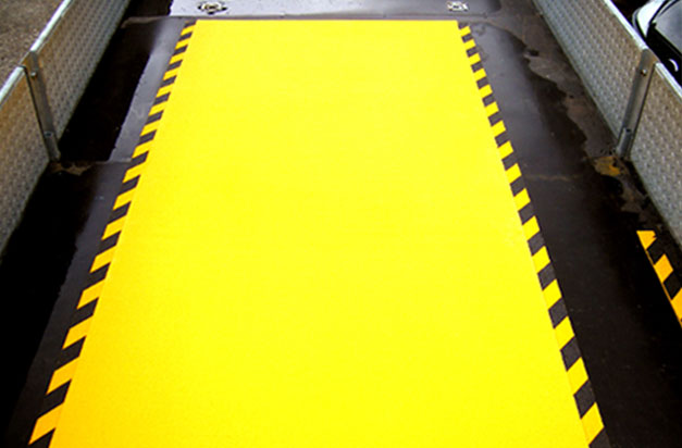 Anti-Slip floor sheets with hazard stripes for a loading area.