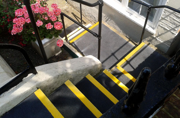 Basement flat entrance made safer with non-slip stair treads and landing covers.