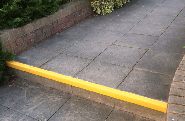 Yellow stair nosings provide contrast, highlighting the step edge.