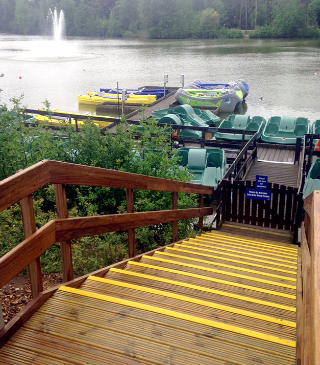 Slippery wooden steps and platforms made safe with highly visible yellow anti-slip stair nosing.