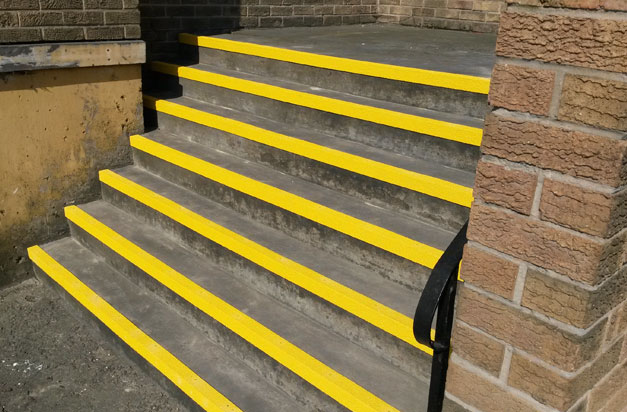 Stairwell entrance steps with DDA compliant yellow stair nosing.