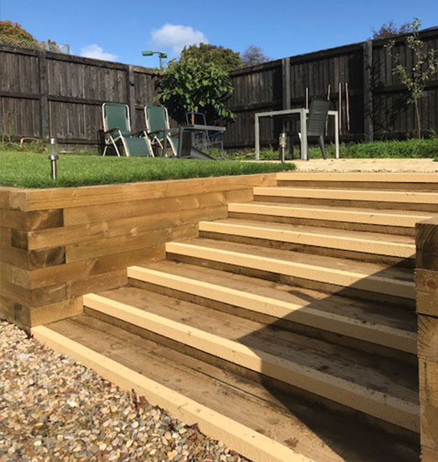 Buff stair nosing compliments the colour of timber steps for a garden landscape design.
