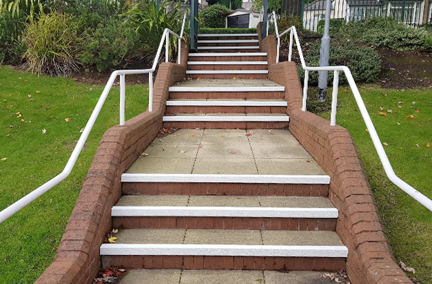 Completed, with white DDA compliant nosings applied to concrete slab steps.