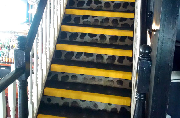 Anti-slip stair tread covers on an interior staircase.