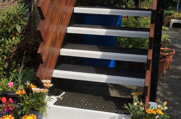 Garden flat entrance made safe with black and white anti slip stair treads.