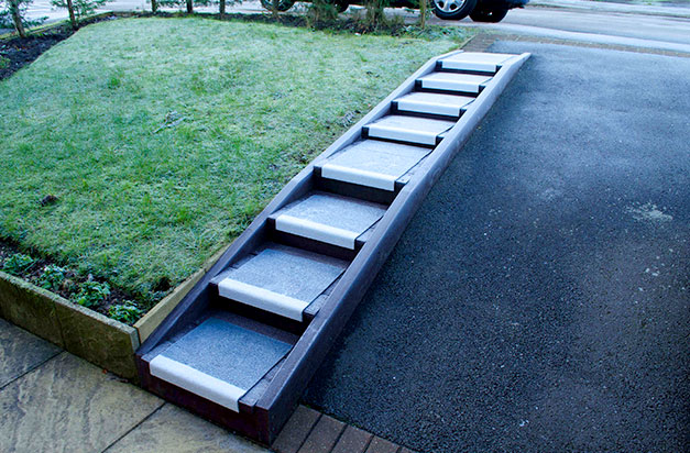 “Anti-slip Stair Treads steps fixed to lumber built on a steep drive. The steps became slippery in frost (as at the time of the photo) but the Safe Tread product removed this hazard.” B Skinner.