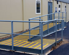 Access ramp with anti-slip decking strips for safety.