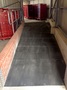 Warehouse ramp walkway with anti slip floor sheets.
