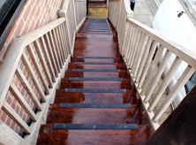Black stair nosing on slippery timber steps.