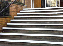 Stair nosing installation on concrete steps.